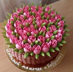 a cake decorated with pink flowers and green leaves