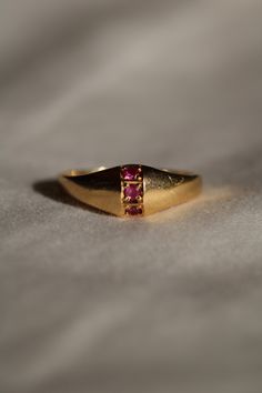 This vintage ruby ring is a super sweet little piece. Crafted in 14k yellow gold it featured three small genuine rubies the descend down the front of it's domed top. The front measures 7mm at it's widest point and it tapers to the back. The inside is engraved with the initials "K.F.D.". It is currently a size 7.25 but could be resized by your local jeweler. I do not offer resizing services at this time. This piece is in excellent vintage condition and is suitable for everyday wear! Vintage Ruby Ring, Rubin Ring, Ruby Ring Vintage, Ruby Ring, Super Sweet, Rings Statement, Statement Rings, Ruby, Everyday Wear