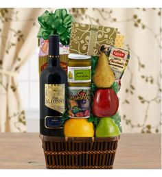 a bottle of wine and some fruit in a basket