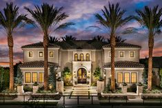 a large house with palm trees in front of it