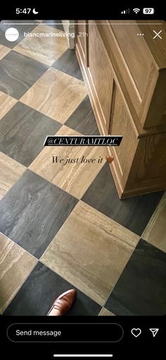 a black and white checkered floor with a wooden cabinet in the background that says,