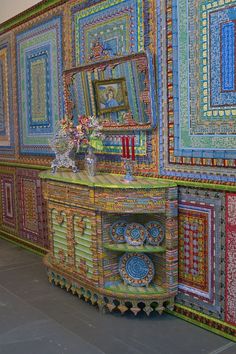 an artisticly decorated wall with many different colors