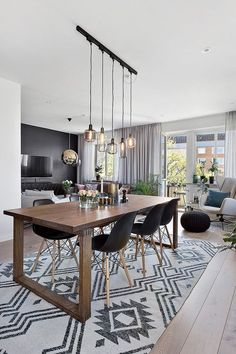 a dining room table surrounded by chairs and lights