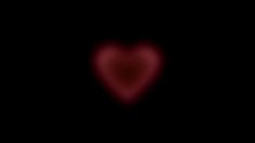 a heart shaped object in the dark with red light coming from it's center