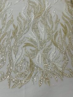 an embroidered fabric with gold and silver sequins