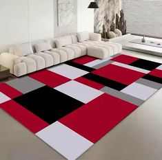 a modern living room with red, black and white rugs on the floor next to a couch