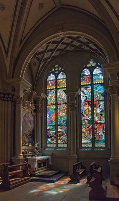 the inside of a church with stained glass windows