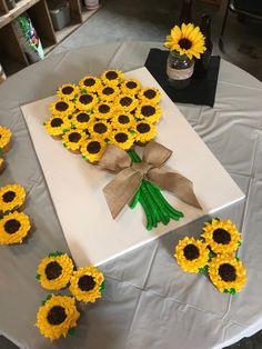 sunflowers are arranged on a white table