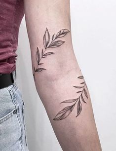 a woman with a tattoo on her arm is holding onto the arm of another person