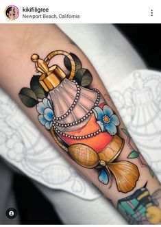 a woman's arm with an umbrella and bells tattoo design on the left forearm