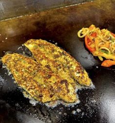 two pieces of fried food sitting on top of a grill