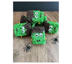 there are some green treats with googly eyes in the shape of monsters on them