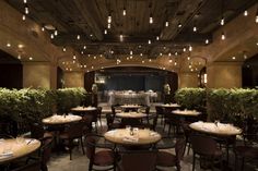 an empty restaurant with tables and chairs set up for formal dinnereons in the center