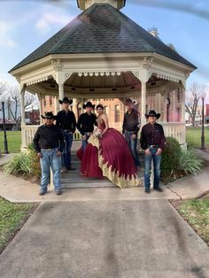 a group of people standing in front of a gazebo