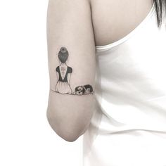 a woman's arm with a small tattoo on the left side of her arm