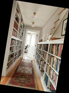 the hallway is full of books and rugs