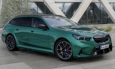 a green car parked in front of a building