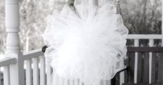 a black and white photo of a person wearing a tutu skirt on the porch