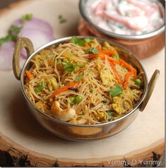 two bowls filled with food sitting on top of a wooden table