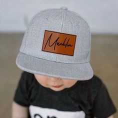 These Signature patch hats are perfect for any Toddler or kid. You can customized them with any name or word in the cute cursive font. We have several different colors and fonts to choose from.  CARE OF the HAT: patches shouldn't be cleaned at all but if need to sponge can be used slightly using little water. hat inside and sweatband area can be cleaned with mild detergent . spot clean. hard to get rid of areas a soft brush can be used. never put hat in washer machines or put in dryer air dry outside or inside please HAT SIZES: all hats are adjustable snap back. Baby 6m - 3years 46-50cm head circumference Junior 4-8 years 50-55cm head circumference Adult 55-58 cm head circumference  HOW TO ORDER: 1. pick out your hat size 2. pick out your hat color 3. in the personalization box please ente Personalized Adjustable Brimmed Hats, Personalized Adjustable Snapback Hat With Flat Bill, Custom Name Cap That Fits Most, Personalized Adjustable Flat Bill Hats, Custom Name Cap Hat One Size Fits Most, Custom Name Adjustable Hat As Gift, Cute Personalized Snapback Hat, Custom Name Cap Hat As Gift, Personalized Snapback Hat