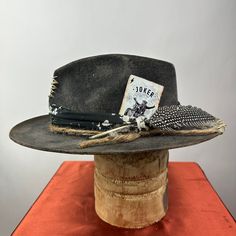 *PRICE INCLUDES $15 HAT BOX* Premium Wool Felt  4 1/4 Crown, 2 3/4 inch brim shown  Custom Color, Distressing, Band and Accessories Colors may vary slightly. Although each hat is unique a similar hat can be made in various sizes.  All Sales Final Rustic Kentucky Derby Hat With Curved Brim, Rustic Curved Brim Hat For Kentucky Derby, Rustic Fitted Hat For Kentucky Derby, Rustic Flat Brim Fedora For Kentucky Derby, Black Artisan Fedora Felt Hat, Rustic Fitted Hat With Curved Brim, Artisan Black Fedora Felt Hat, Black Artisan Felt Hat With Short Brim, Black Artisan Felt Hat With Wide Brim