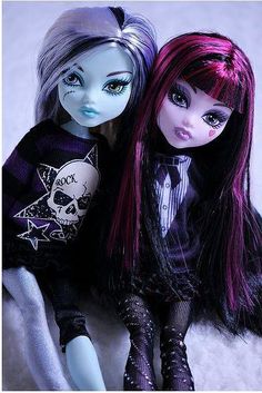 two dolls are sitting next to each other