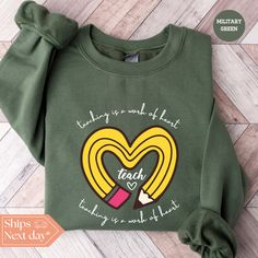 All of our Teaching Is a Work of Heart hoodies are handmade to order on an ultra soft crewneck that will quickly become your go to apparel item! You will never want to take it off! Our Teacher sweatshirts are handmade to order with eco-friendly water based ink that feels good and lasts longer! ♥The details♥ This unisex sweatshirt is crafted from soft, breathable fabric for ultimate comfort. Printed with an eco-friendly water-based ink, this sweater not only looks great but also supports sustainable practices. The unisex sizing allows for a versatile fit, but we suggest sizing up for a more relaxed look. To keep your crewneck looking its best, we recommend washing it on cold and either hanging it to dry or tumble drying it on low heat. Be sure to avoid ironing directly on the design to pres New Teacher Gift, New Teacher Gifts, Teacher Sweatshirt, New Teacher, Teacher Inspiration, Heart Hoodie, Heart Sweatshirt, Kindergarten Teacher, Sustainable Practices