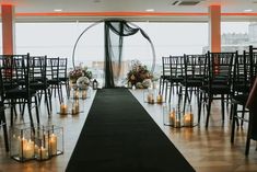 an indoor ceremony setup with candles and flowers