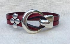 A stylish leather bracelet for women that is both casual and dressy - it looks great alone or as a stacking bracelet. The leather wraps once around your wrist and then easily hooks into the silver toned clasp. The simple, four dot slider bead finishes the look and ensures that the bracelet is firmly Chic Adjustable Leather Bracelet, Handmade Red Wrap Bracelet, Elegant Leather Wrap Bracelet As Gift, Elegant Adjustable Leather Wrap Bracelet, Elegant Leather Wrap Bracelet Gift, Bohemian Leather Bracelet For Everyday Wear, Bohemian Leather Bracelet For Everyday, Adjustable Burgundy Bracelets, Elegant Handmade Leather Wrap Bracelet