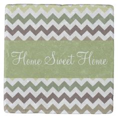 a green and brown chevroned tile with the words home sweet home