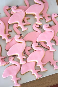 some pink and white decorated cookies on a table