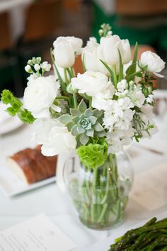 a vase filled with white flowers on top of a table