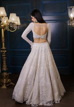 This ivory lehenga set features all over pearl, sequin, crystals, cutdana embroidery and a statement embroidered full sleeve blouse. Paired with an embellished hand embroidered dupatta in net.DELIVERY TIMEPlease allow 8-12 weeks for your outfit to arrive.FABRIC DETAILSNetProfessional cleaning only. Best Lehenga Design, Full Hands Lehenga Blouse Designs, White Embroidery Lehenga, Full Sleeves Blouse Design For Lehenga, Engagement Lehenga Blouse Designs, Full Hand Blouse Designs For Lehenga, Full Sleeves Lehenga Designs, Lehenga Back Neck Design, Lehenga Designs For Diwali