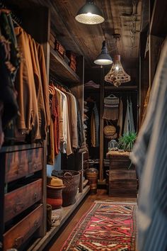 an open closet with lots of clothes hanging on the walls and rugs in front of it