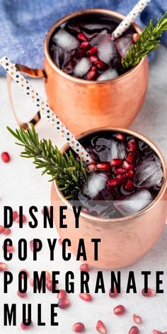 two copper mugs with pomegranate and rosemary garnish on top