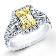 a fancy yellow diamond ring with baguetts and diamonds on the band, set in white gold