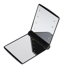 an open mirror with lights in it on top of a white surface and black frame