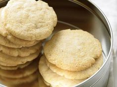 some cookies are in a metal bowl on a table