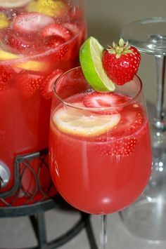 two glasses filled with red liquid next to each other