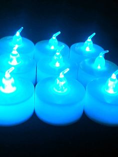 blue lit candles sitting on top of each other