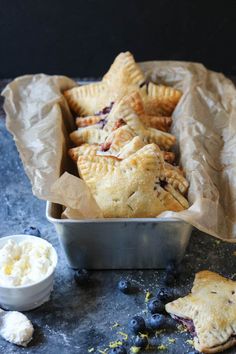 blueberry hand pies in a baking tin with butter