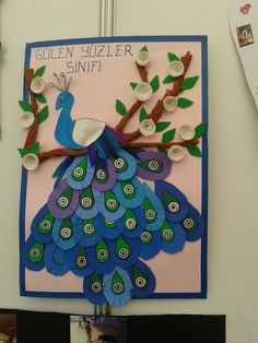 a bulletin board with a blue and green peacock sitting on top of a tree branch