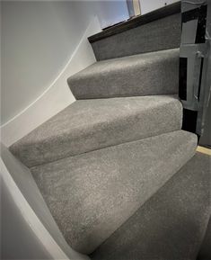 an image of a stair case with carpet