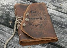 two brown leather journals with writing on them