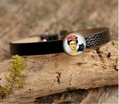 So delightful Frida Kahlo-Inspired Leather Bracelet Set with adjustable straps.Displays three images of the international Mexican icon Frida Kahlo.Theme: PunkMaterial: Faux LeatherMetal: AllowColor: Black LeatherStyle: BangleBracelet chain length: Approx. 6.5 inchGlass Diameter: 0.55 inchThis is an excellent gift idea! They come in a beautiful and elegant gift box. Order Now! Limited Quantities/Limited Edition.Get them fast... ready to ship in one to three business days. Thank you for shopping w Punk Style Adjustable Leather Bracelet, Adjustable Leather Punk Bracelet, Adjustable Punk Style Leather Bracelet, Handmade Punk Leather Bracelet, Adjustable, Adjustable Black Band Leather Bracelet, Multicolor Bracelet, Filigree Bracelet, Coil Bracelet, Jade Crystal