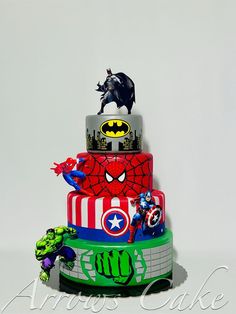 a multi layer cake decorated with captain america, spiderman, and hulk - man figurines