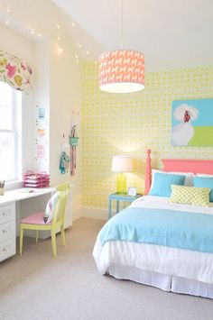 a bedroom decorated in pastel colors with white and yellow accents, including a large painting on the wall