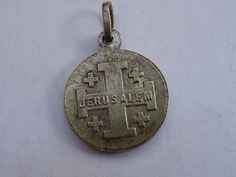 Antique religious silvered medal pendant of Jerusalem and Holy Christ. On the front is Holy Christ. At the other side is written: Jerusalem Measures: 0,63 x 0,74 inches ( 1,61 x 1,9 cm ) I bought the medal on a brocante ( flea market ) in France. I deliver all over the world. Registered shipping is possible. If you haven't Paypal, you can pay by bank transfer. I have a lot of this medals. If you have a question feel free to ask. Please take also a look at my other items for sale. Commemorative Coin Pendant, St Therese Of Lisieux, Thérèse Of Lisieux, Our Lady Of Sorrows, St Therese, Catholic Medals, Patron Saints, Cross Charms, Bank Transfer