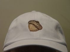 NEW EMBROIDERED ACORN MEN WOMEN WILDLIFE BASEBALL HAT AUTUMN OAK TREE HAT (HATS SHOWN ARE WHITE, FOREST GREEN, BLACK, CARIBBEAN BLUE, NAVY BLUE AND BURGUNDY) Adams Optimum 6 Panel Baseball Hat Low Profile - 100% Cotton Twill Adult Cap Pigment Dyed - Garment Washed Hat 6 Panels with Sewn Matching Eyelet Visor with 3 Rows of Stitching Pre-formed Bill - Leather Strap with Brass Grommet Adjustable - One Size Fits Most An Extremely Comfortable Baseball Hat! Enjoy the Embroidered Oak Acorn Hat Please White Cotton Hats With Custom Embroidery, Custom Embroidered White Hat, White Custom Embroidered Hat, Embroidered White Trucker Hat With Flat Bill, Curved Brim Embroidered Baseball Cap, Embroidered Curved Brim Baseball Cap, White Embroidered Dad Cap, White Embroidered Adjustable Dad Hat, Adjustable White Embroidered Dad Hat