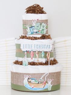 three tiered diaper cake with little fishpihan on the top and bottom